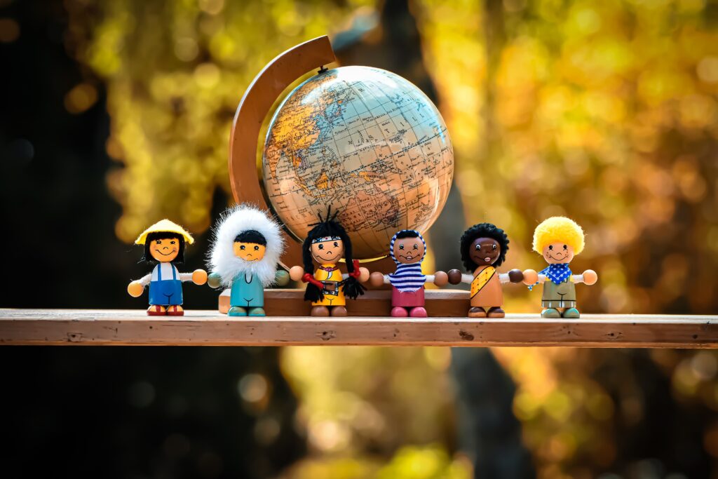What does community mean to you? Toys of all nationalities by a globe.