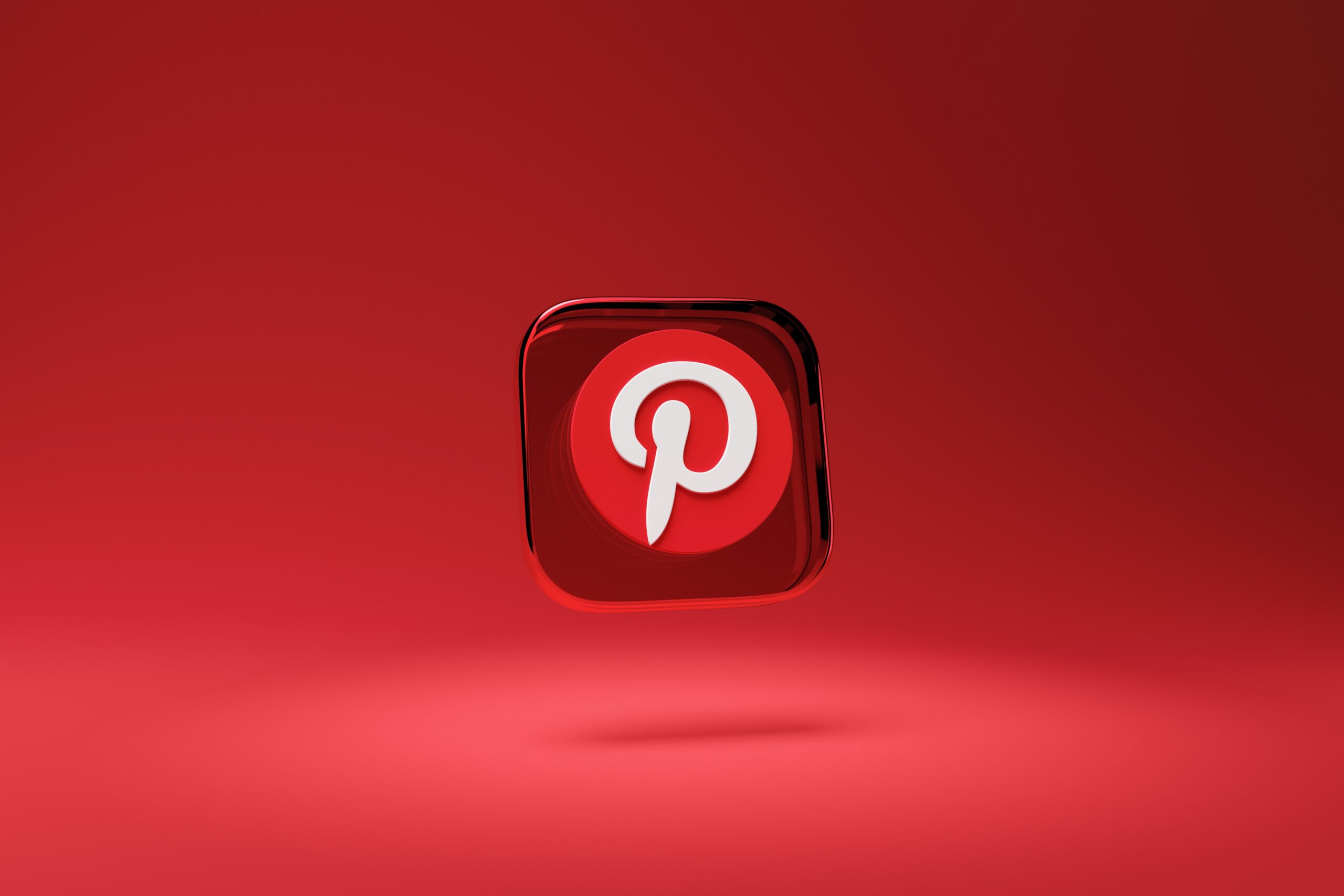 The Pinterest icon floating in a red background